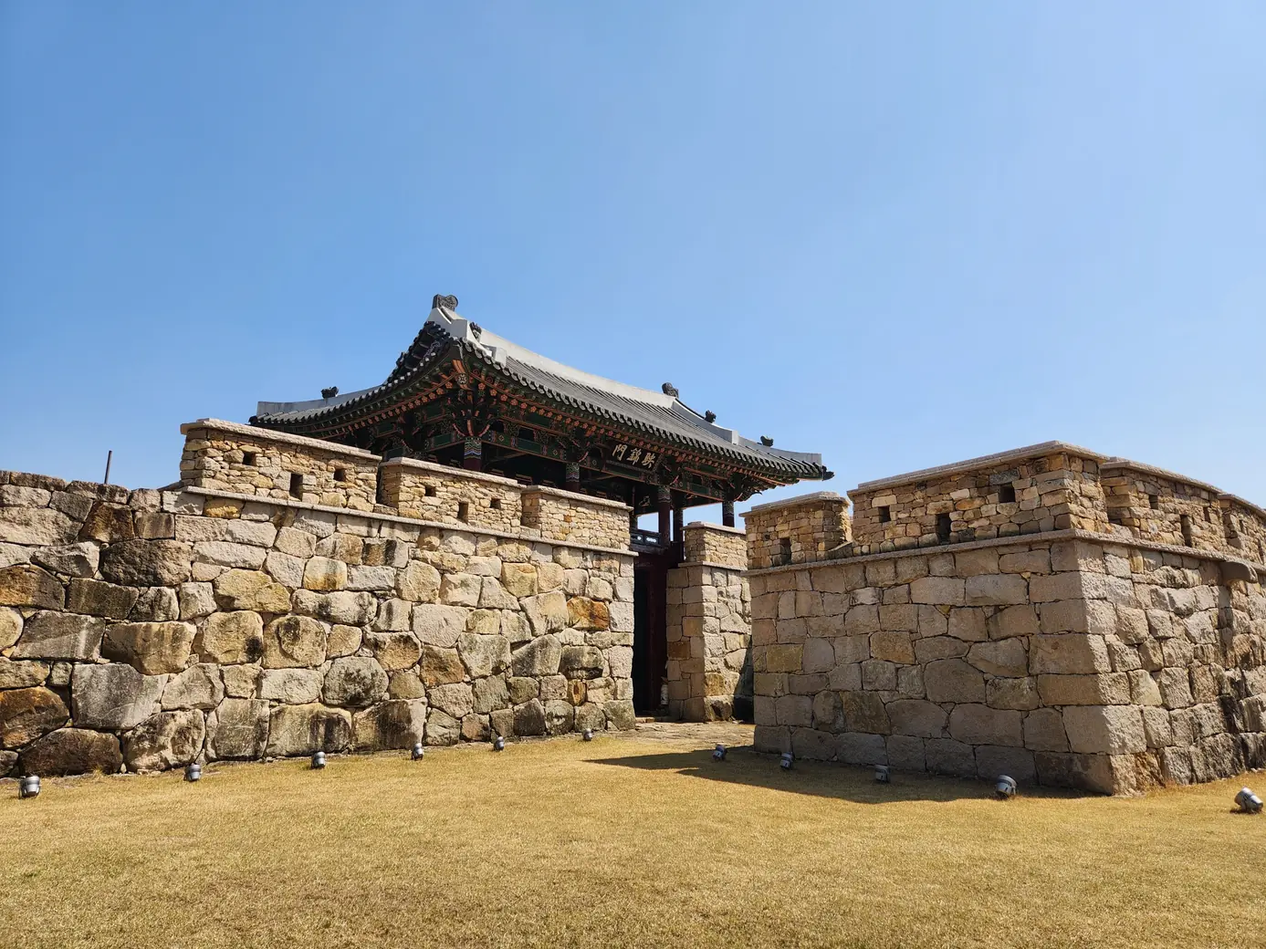 A gate tower rising above the dry-stone wall of the old walled town at Naju