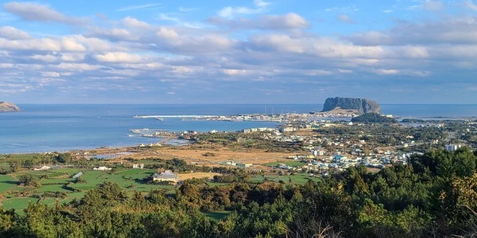 Seongsan Ilchulbong and U-do seen together from the top of a low grassy cone