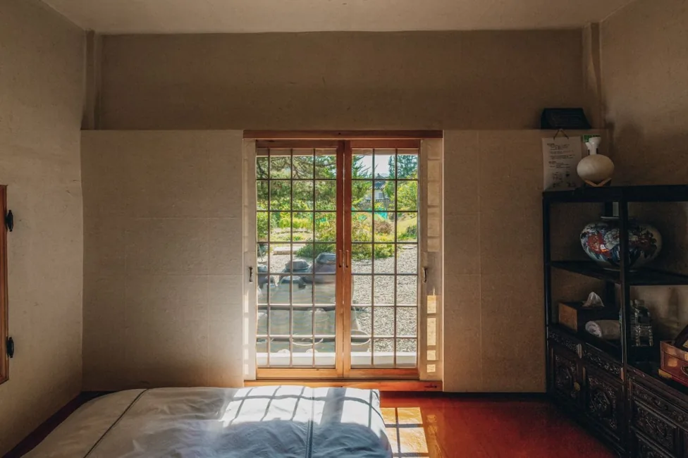 A latticed timber door and a display cabinet inside a hanok room