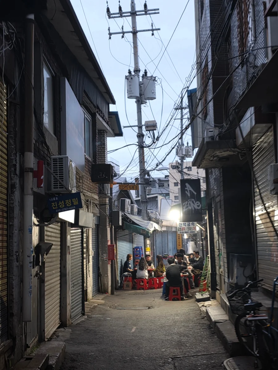Euljiro alley at dusk, print shops closing as street tables fill